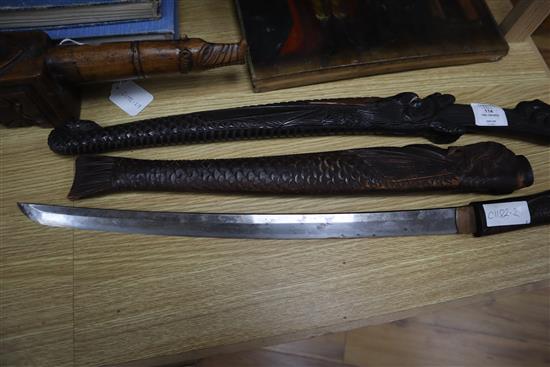 Two 19th century Japanese swords the wood scabbards, carved as a dragon and a merman longest 67cm
